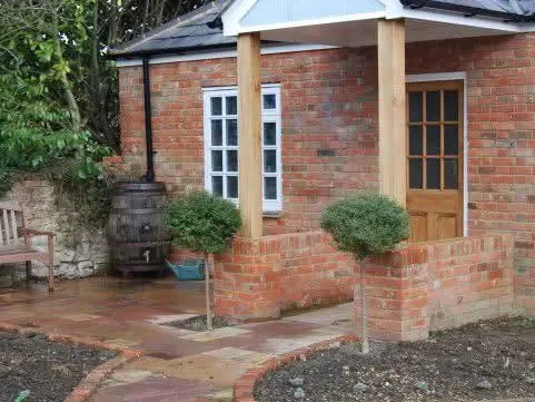 Finished extension with a new brick-paved path and fresh planting